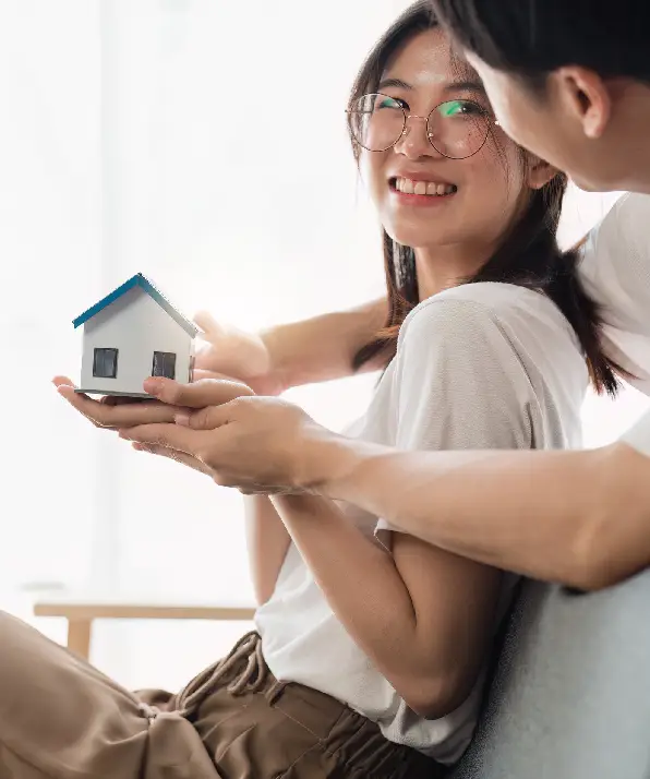Happy asian family young couple holding house bank to save for saving money wealth to buy real estate for new home Happy asian family young couple holding house bank to save for saving money wealth to buy real estate for new home